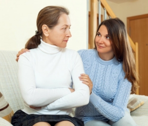 caregiver comforting a middle aged woman