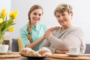 caregiver and elderly woman smiling